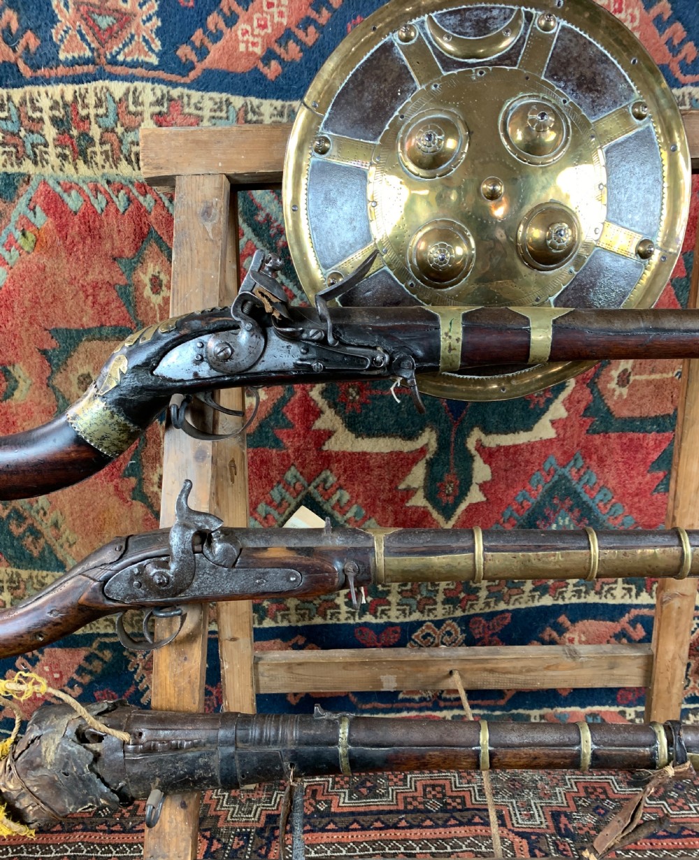 Display of antique Arabian jezail and matchlock guns and an Indian dahl View IV