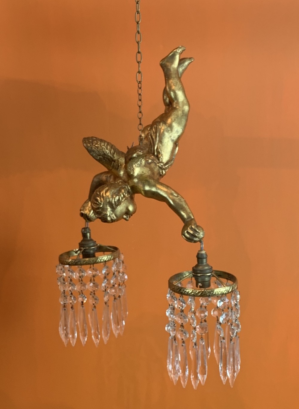 Gilt cherub chandelier hung with cut glass drops