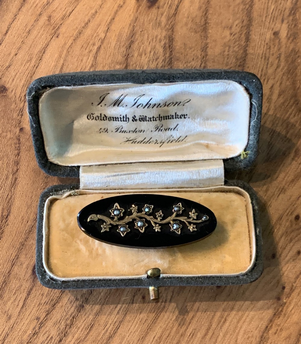 Victorian onyx brooch with a seed pearl set gold branch