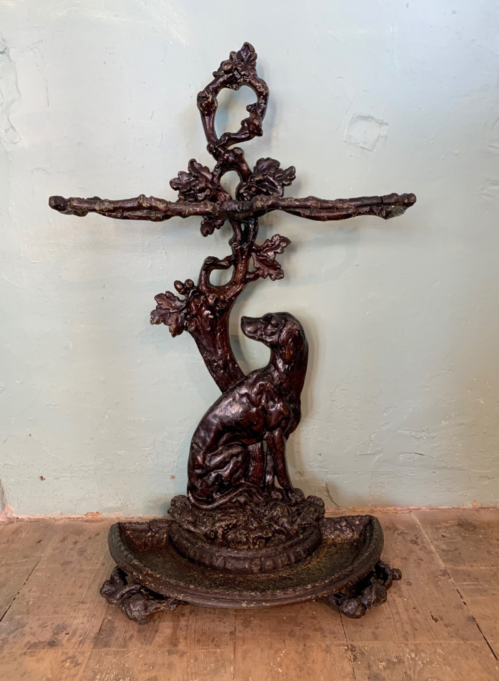 Victorian cast iron stick stand in the form of a dog seated before a tree