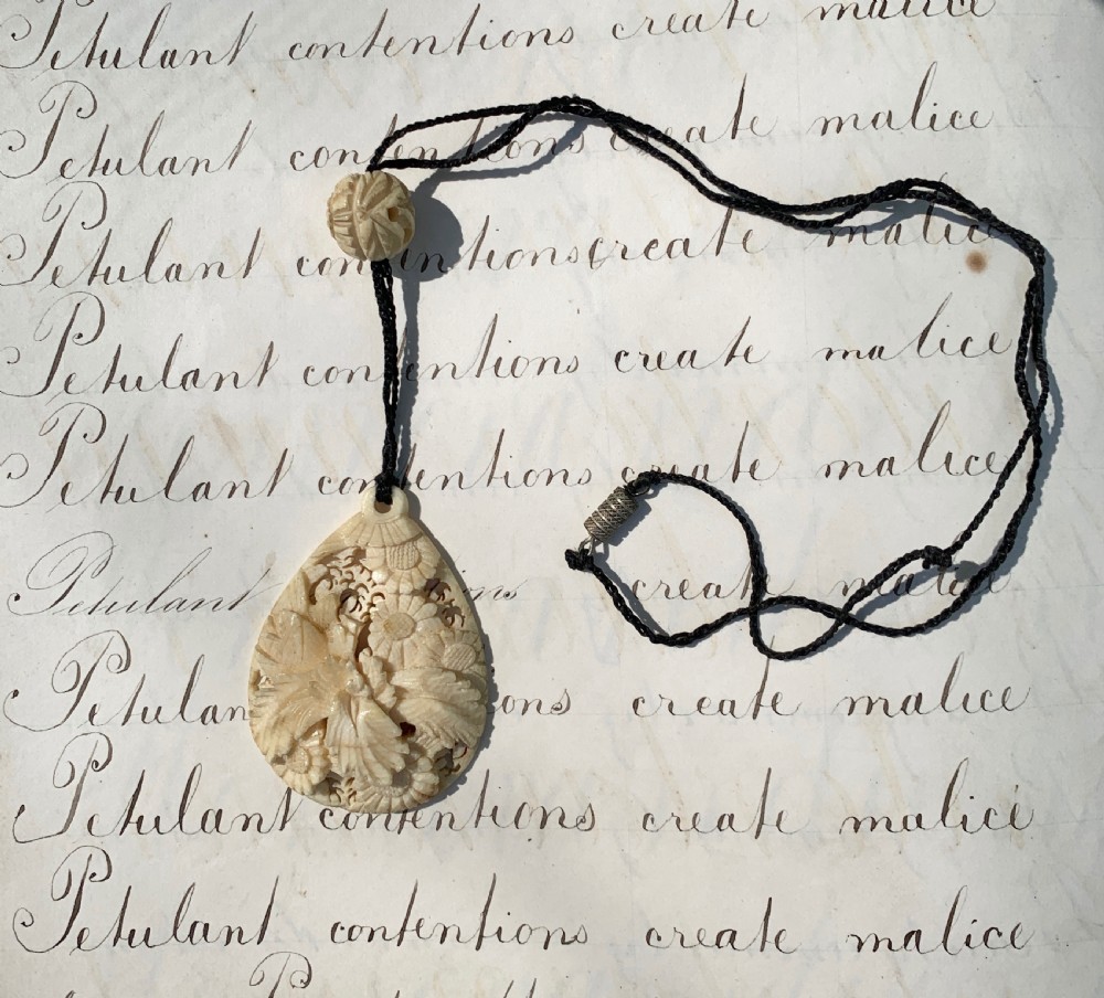 Antique carved stag horn pendant necklace with foliate decoration