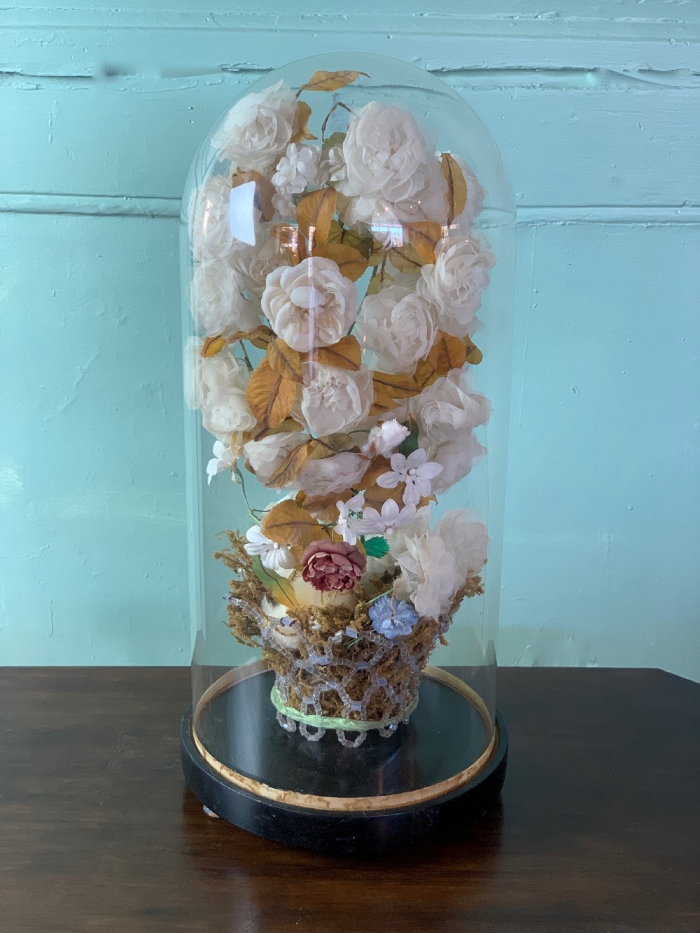 Victorian glass dome with a silk flower display in glass beaded basket