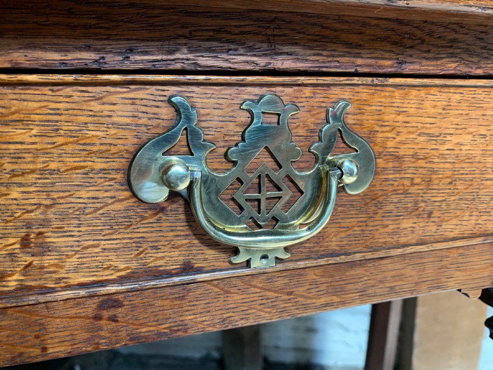 Georgian oak lowboy with three frieze drawers and pierced brass handles View VII