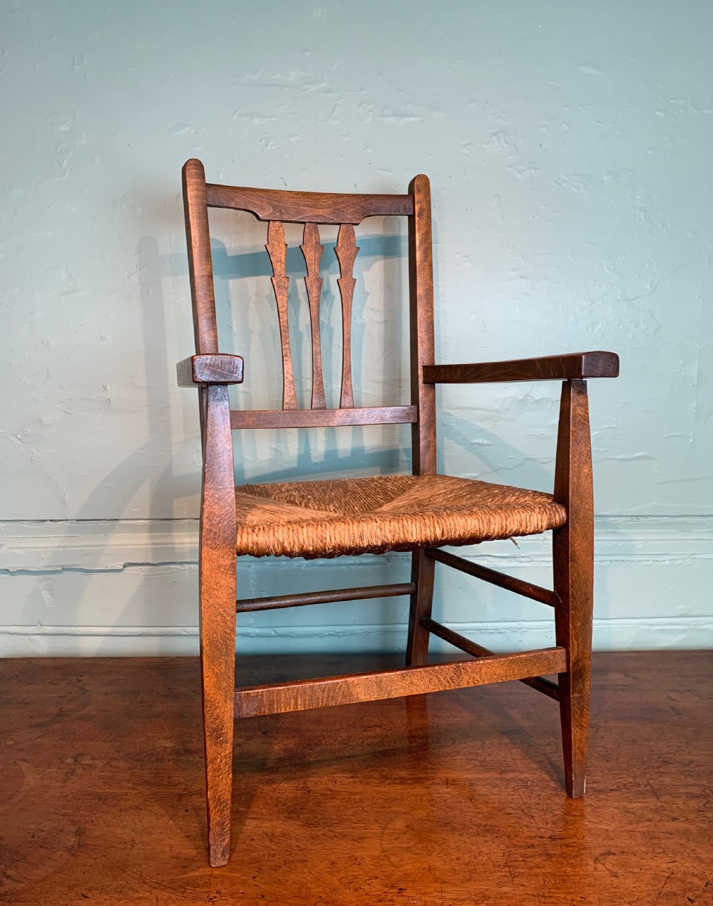 Antique rush seated child's chair in Arts & Crafts style View II