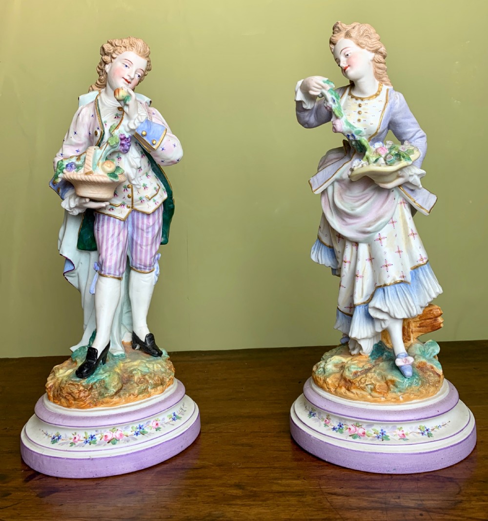 Pair of French bisque porcelain figures with baskets of flowers View II