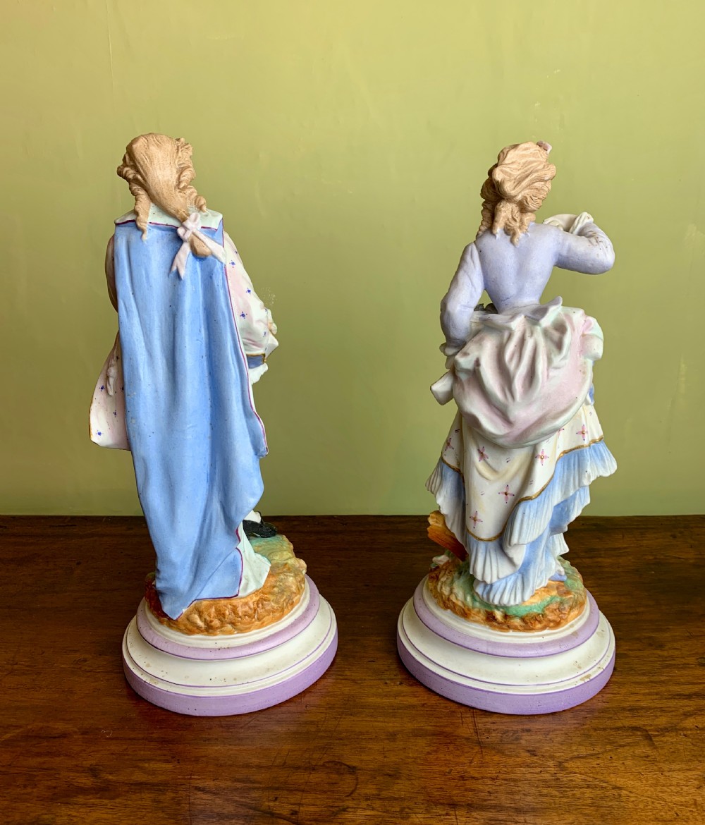 Pair of French bisque porcelain figures with baskets of flowers View V