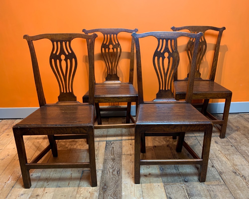 Set of four Georgian provincial oak dining chairs with solid seats View III
