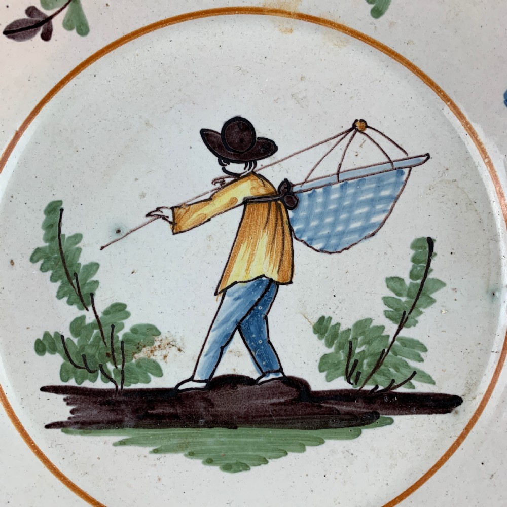 Antique French faience plate painted with a fisherman View II