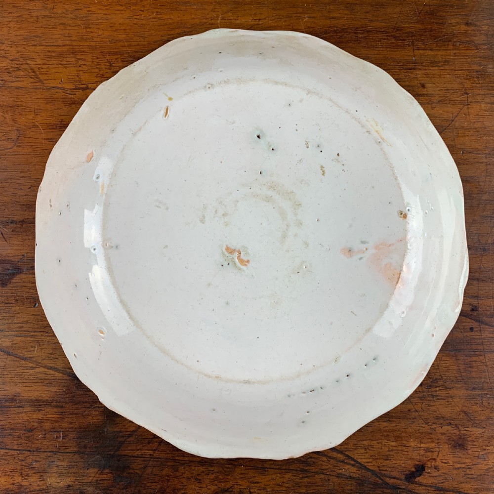 Antique French faience plate painted with a fisherman View III