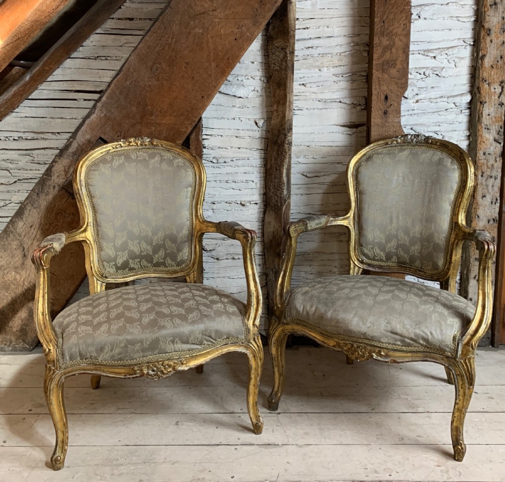 Pair of French gilt-wood fauteuils armchairs in Louis XV style 19th century