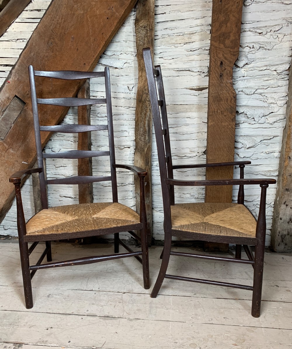 Pair of Arts & Crafts stained beech ladder back chairs with rush seats View II