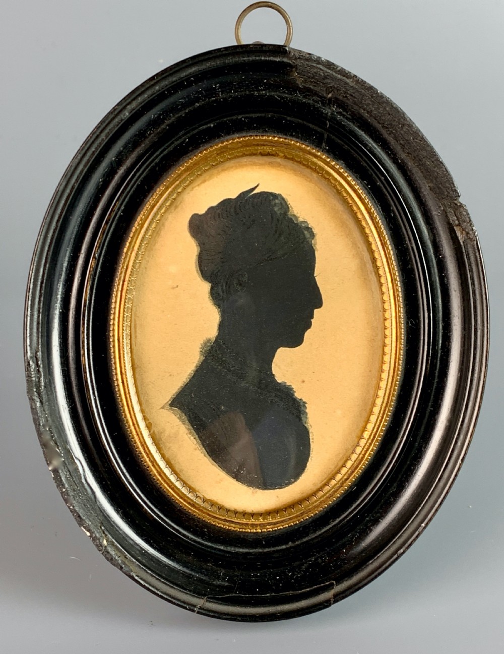 A Regency portrait silhouette of a lady within an ebonised oval frame