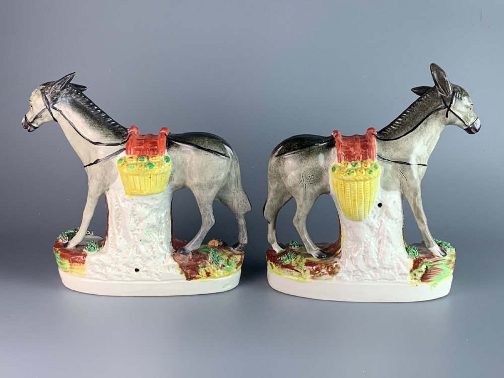 Pair of Victorian Staffordshire pottery donkeys carrying paneers View IV