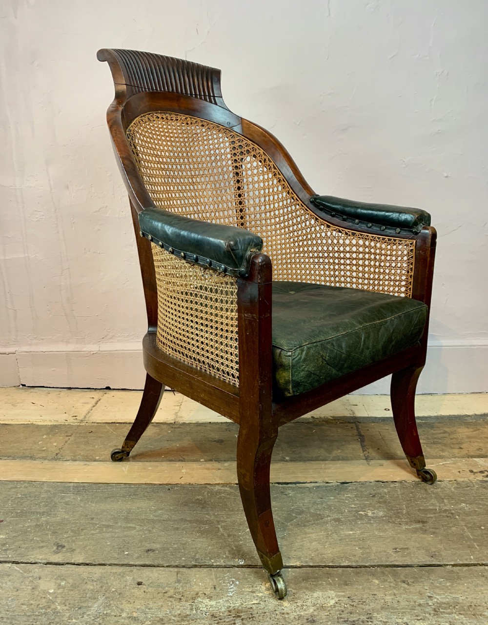 Regency mahogany bergere library armchair with loose leather cushion seat View II