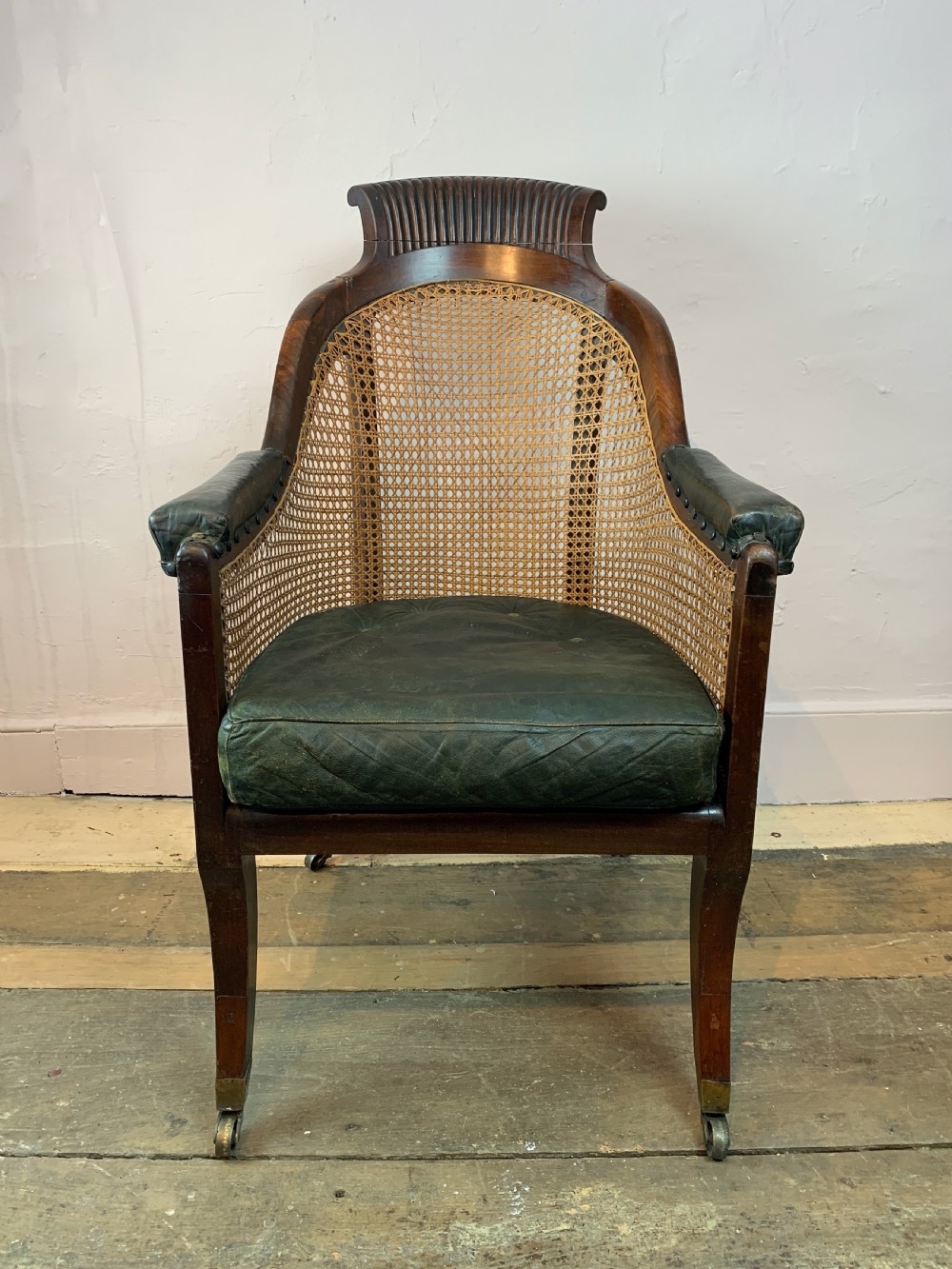 Regency mahogany bergere library armchair with loose leather cushion seat View VI