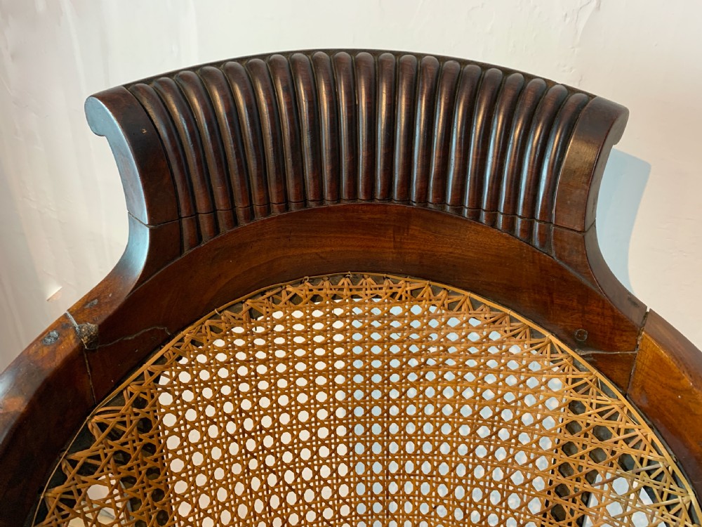 Regency mahogany bergere library armchair with loose leather cushion seat View VIII