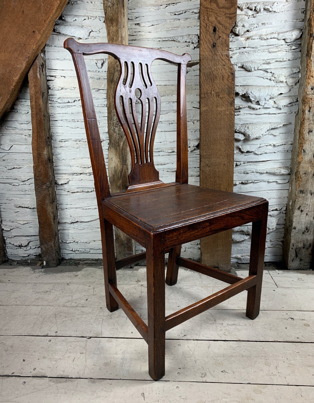 Provincial Georgian oak chair with solid seat and of Chippendale design