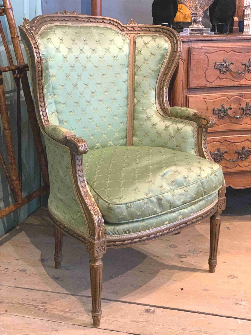 Antique French giltwood wing-back armchair in Louis XVI style
