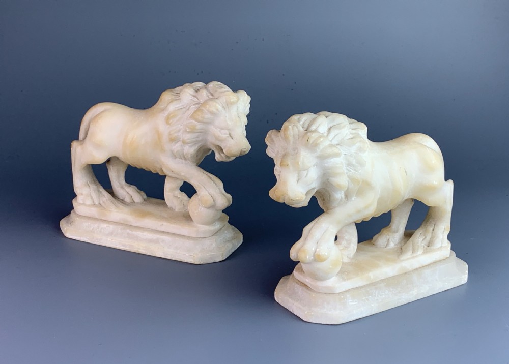 Pair of Grand Tour carved alabaster Medici lions