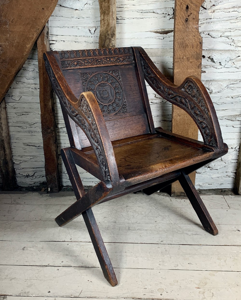 Victorian oak Glastonbury chair carved with the Crown of Thorns