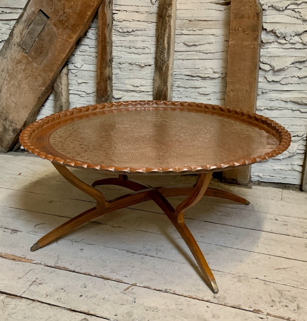 Huge Indian engraved copper tray table upon folding stand