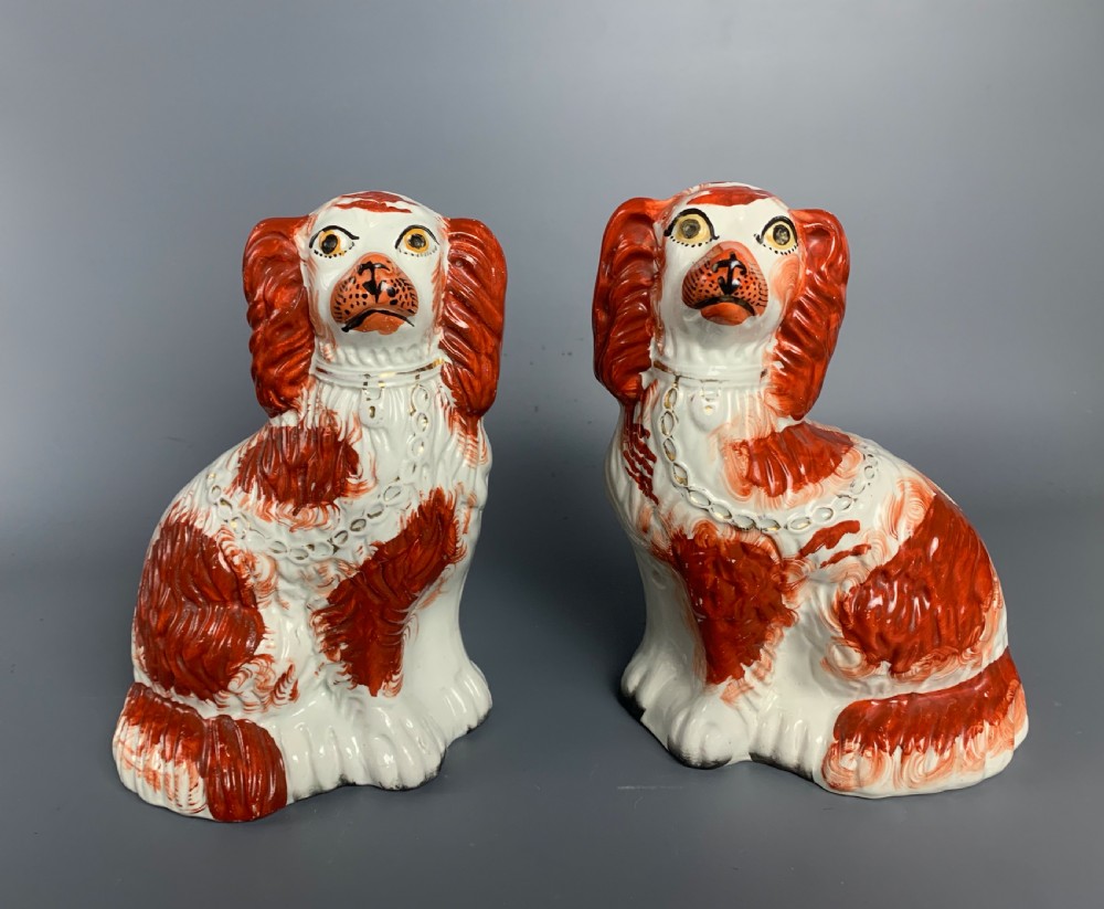 Pair of Victorian Staffordshire pottery white and tan spaniels dogs