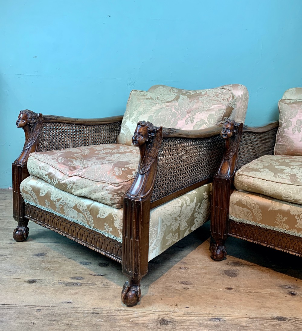 Pair of Edwardian bergere armchairs with angel carved arm terminals