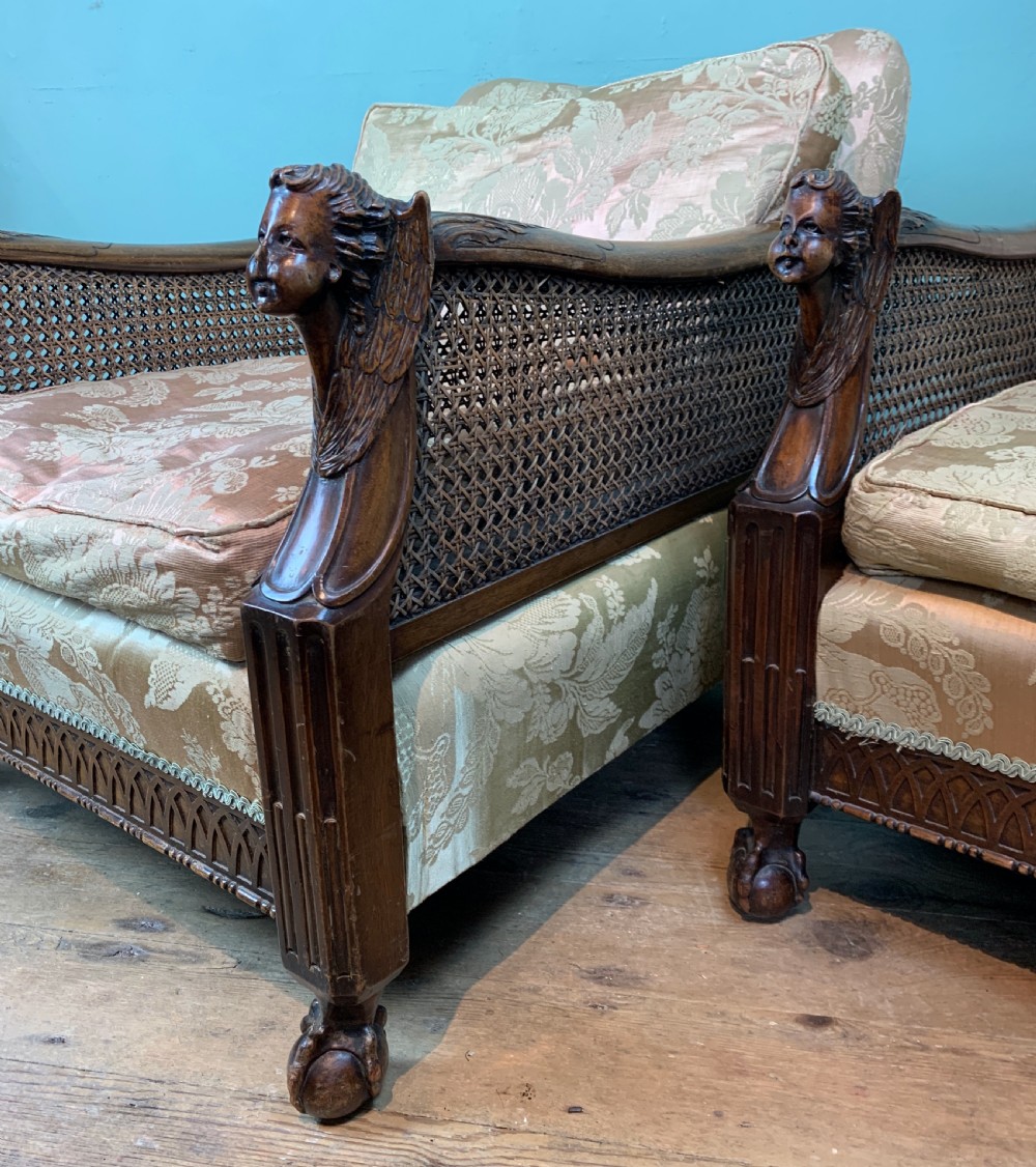 Pair of Edwardian bergere armchairs with angel carved arm terminals View III