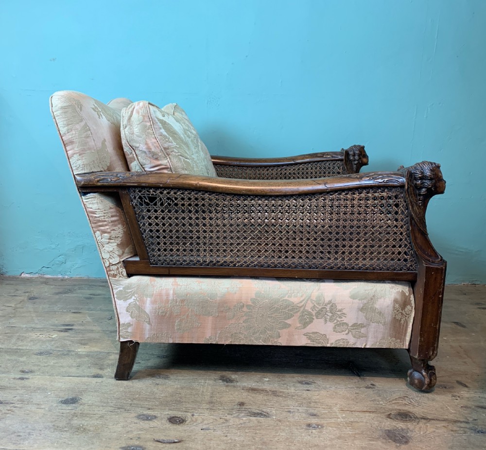Pair of Edwardian double caned bergere armchairs with carved oak frames View VIII