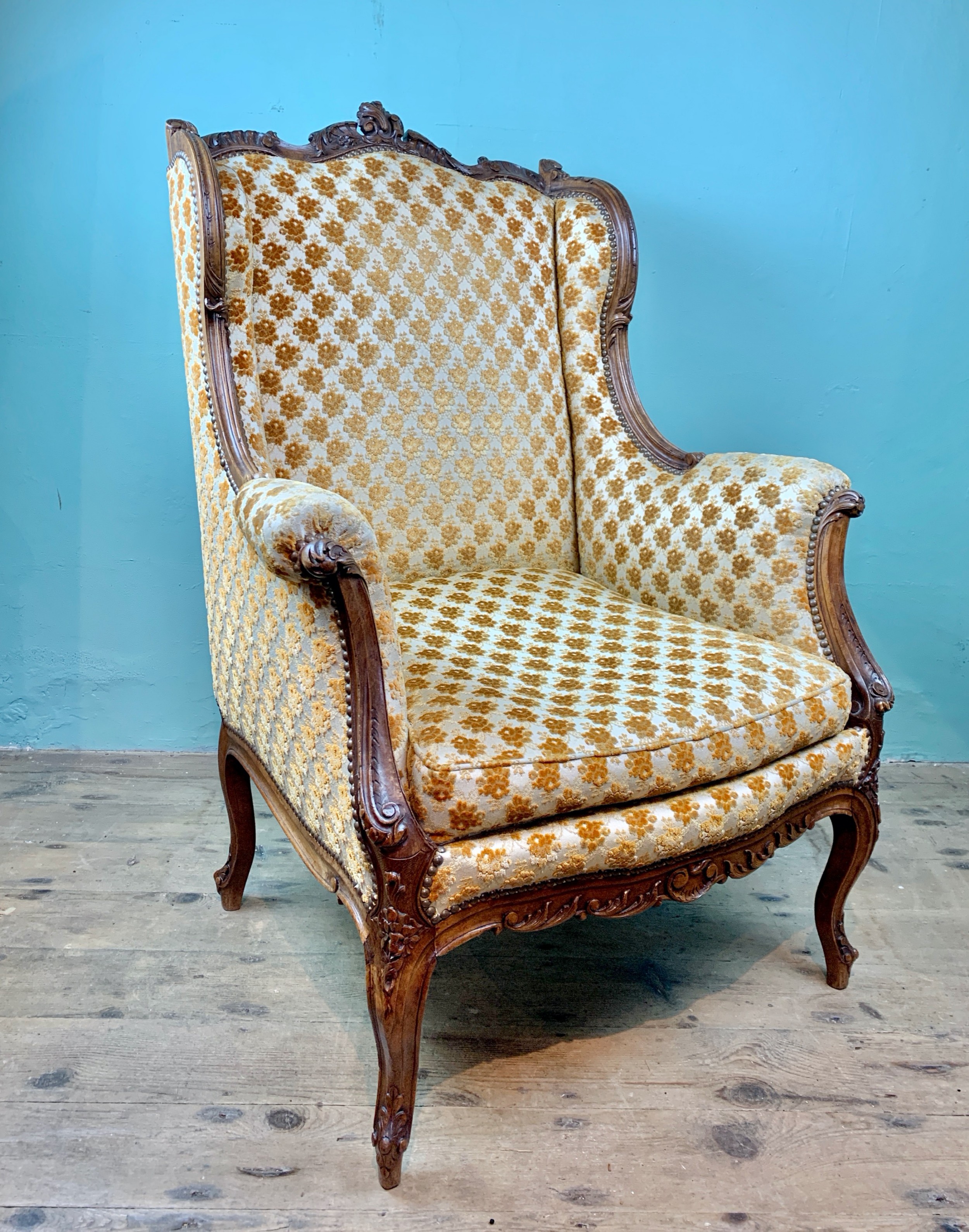 Antique French Louis XV revival wingback armchair of generous proportions