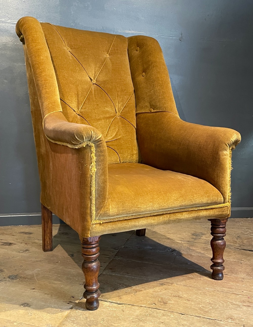 Victorian wingback armchair with buttoned upholstery