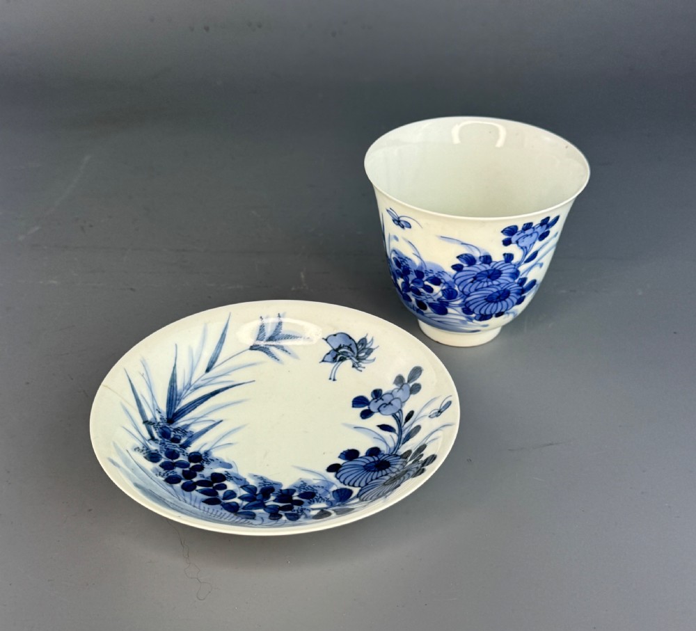A 19th-century Japanese Hirado porcelain wine cup and matching saucer with cobalt blue underglaze hand-painted botanical motifs. View VII