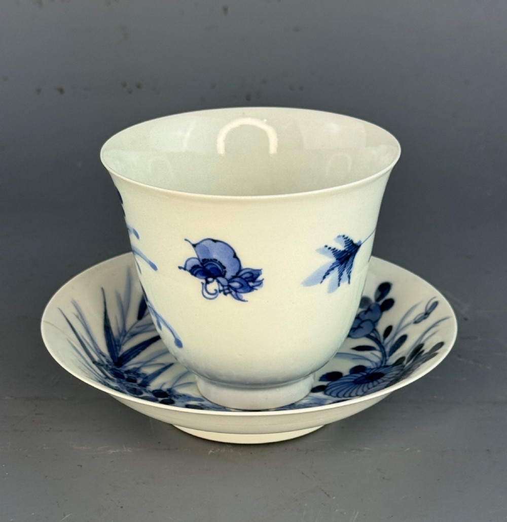 A 19th-century Japanese Hirado porcelain wine cup and matching saucer with cobalt blue underglaze hand-painted botanical motifs. View IX