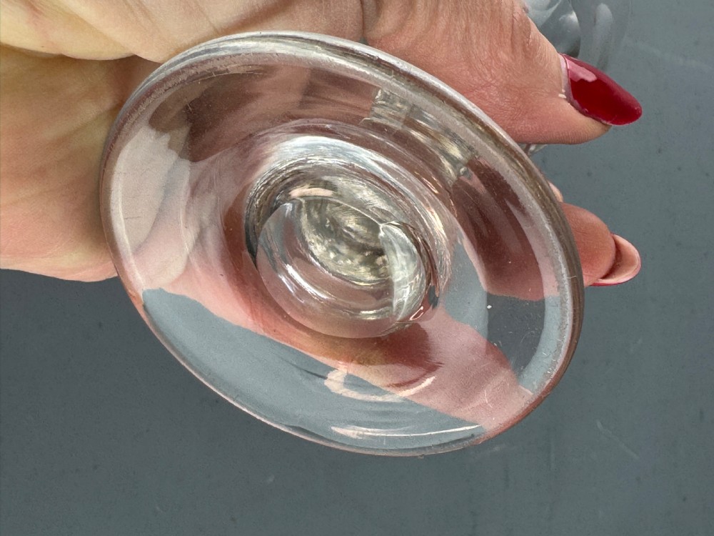 A clear Victorian glass featuring thumb-cut facets around the lower bowl, a short solid stem, and a wide flat base. View II