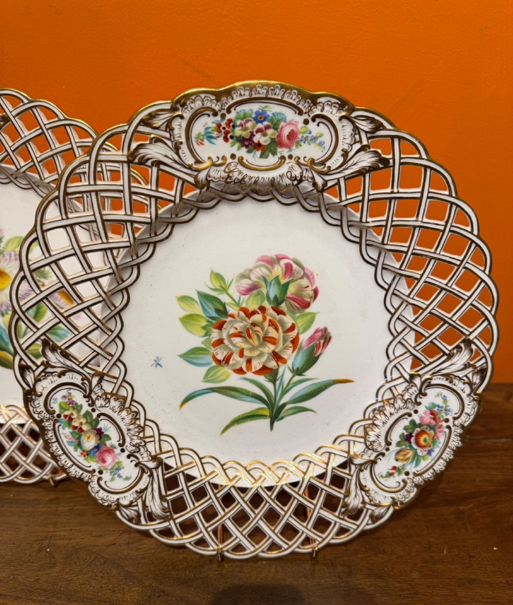 Pair of circular white porcelain plates with reticulated basketweave borders, gilded scrollwork, and hand-painted central botanical sprays. View III