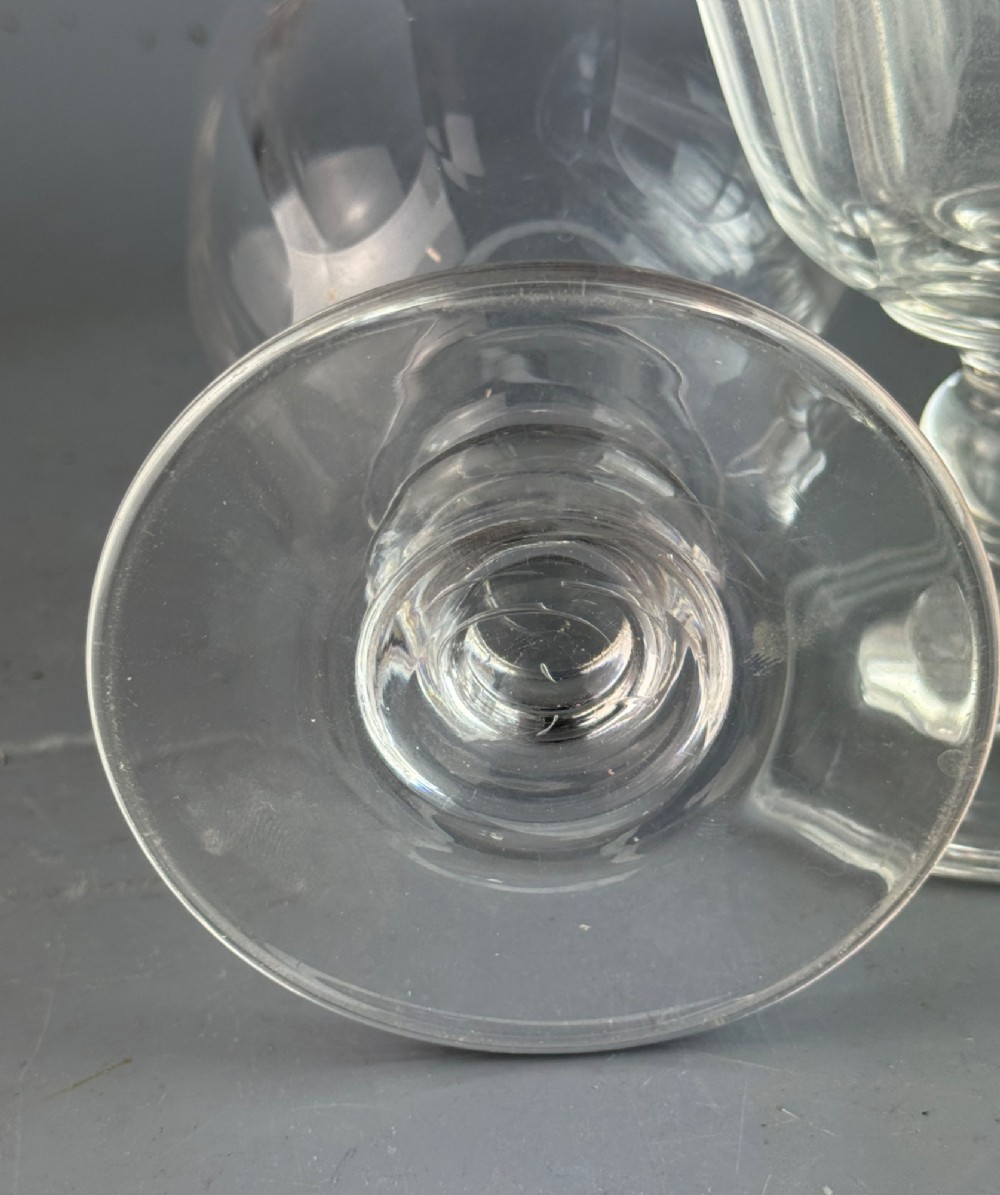 A pair of clear cut glass rummers with fluted lower bowls, short knopped stems, and broad circular bases. View III