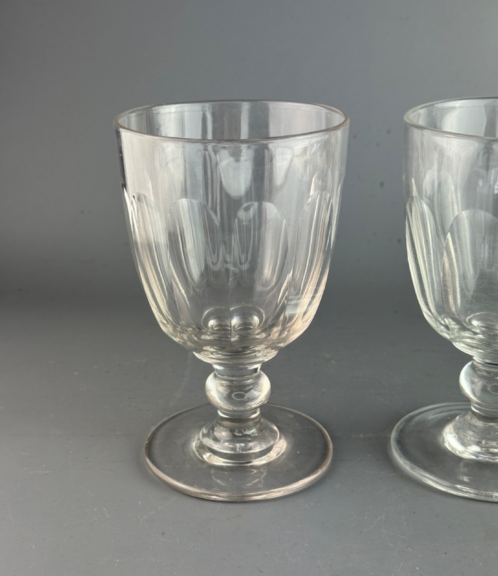 A pair of clear cut glass rummers with fluted lower bowls, short knopped stems, and broad circular bases. View IV