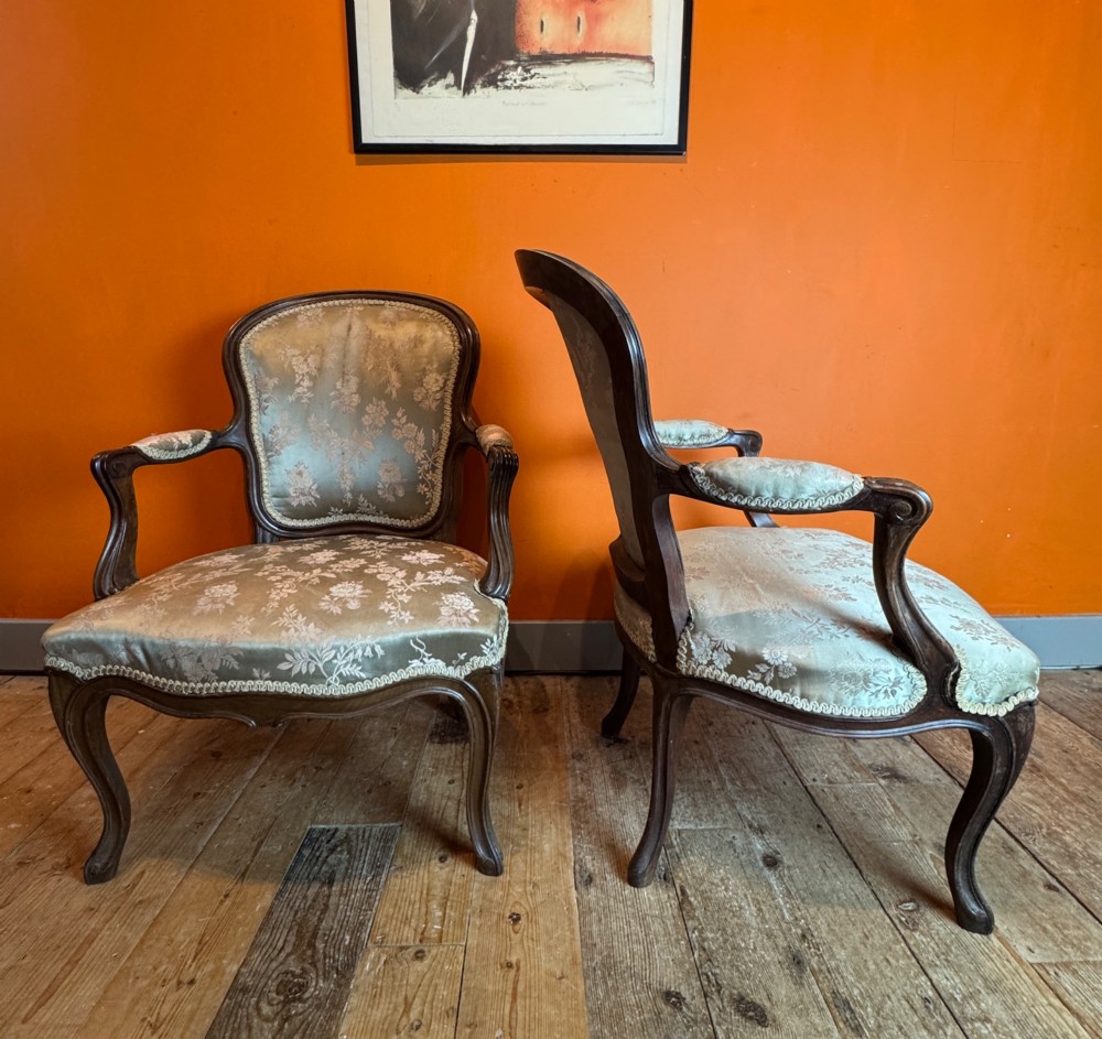 A pair of Louis XV style walnut fauteuil armchairs upholstered in sage green floral silk damask fabric featuring carved cabriole legs. View III