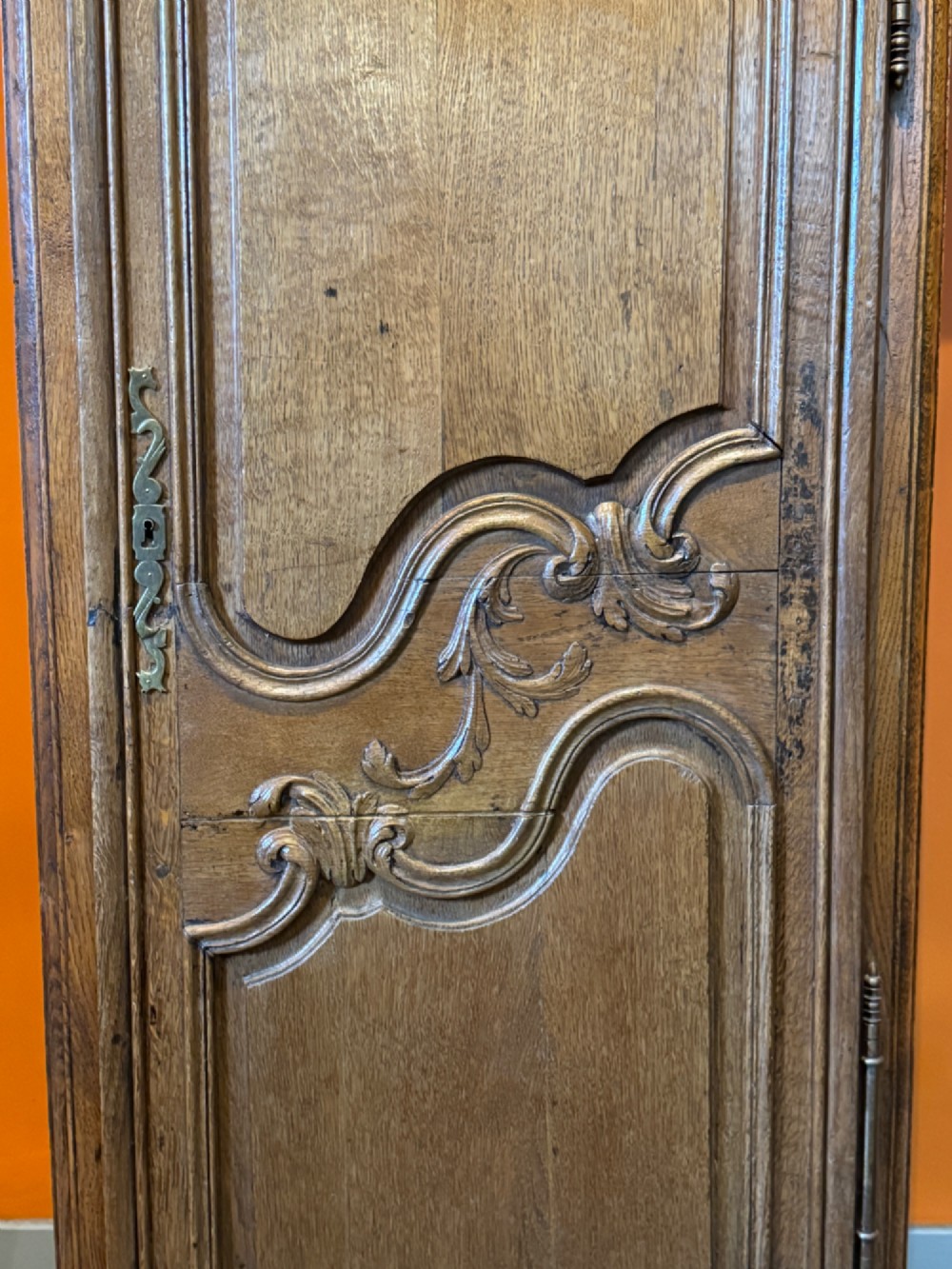A 19th-century French oak bonnetiere featuring a single door with Louis XV style carved foliate mouldings, long iron hinges, and cabriole feet. View IV