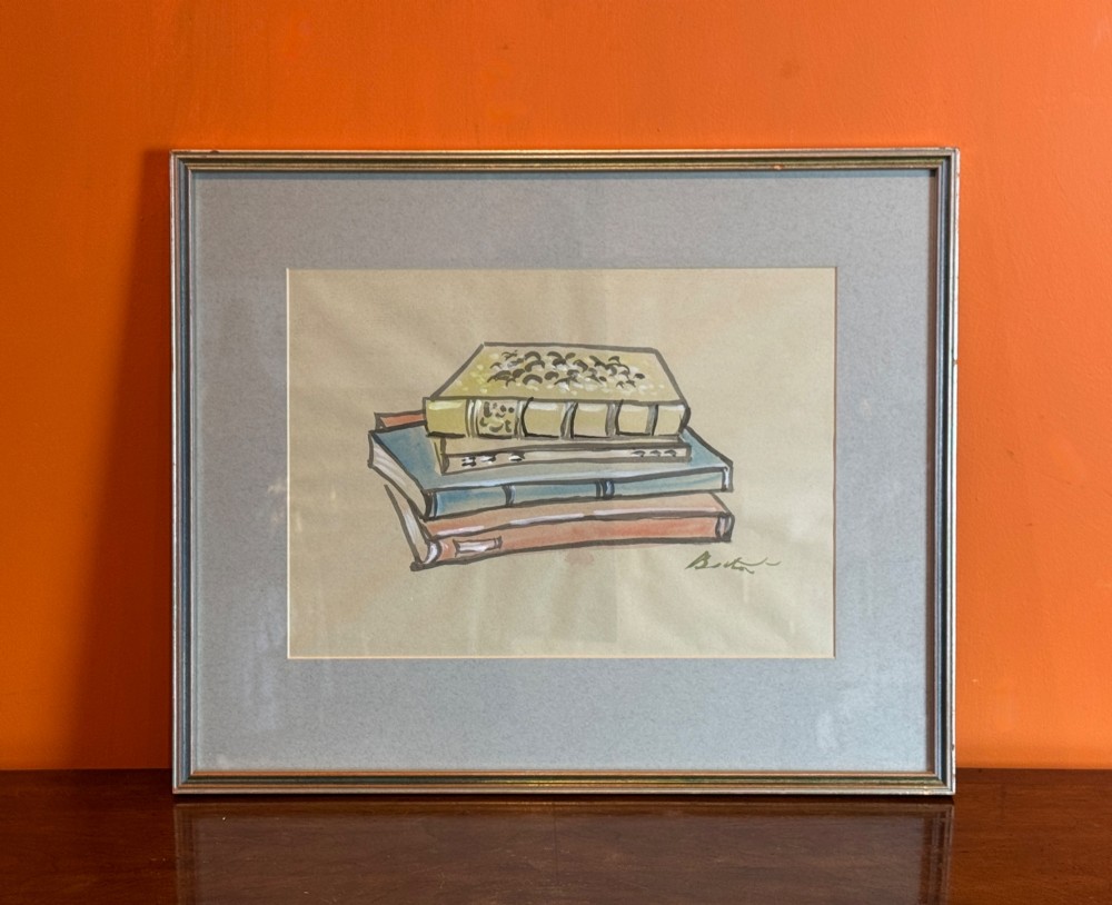 A framed watercolour and ink sketch depicting a stack of four bound books, signed by Cecil Beaton.