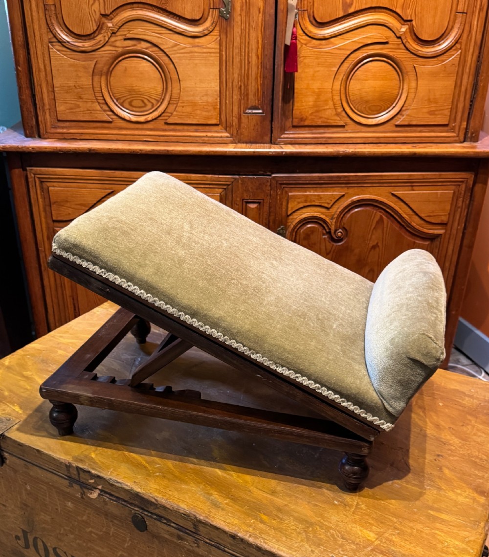 An antique Victorian metamorphic gout stool with a dark stained beech ratchet frame and an inclined green velvet upholstered cushion. View V
