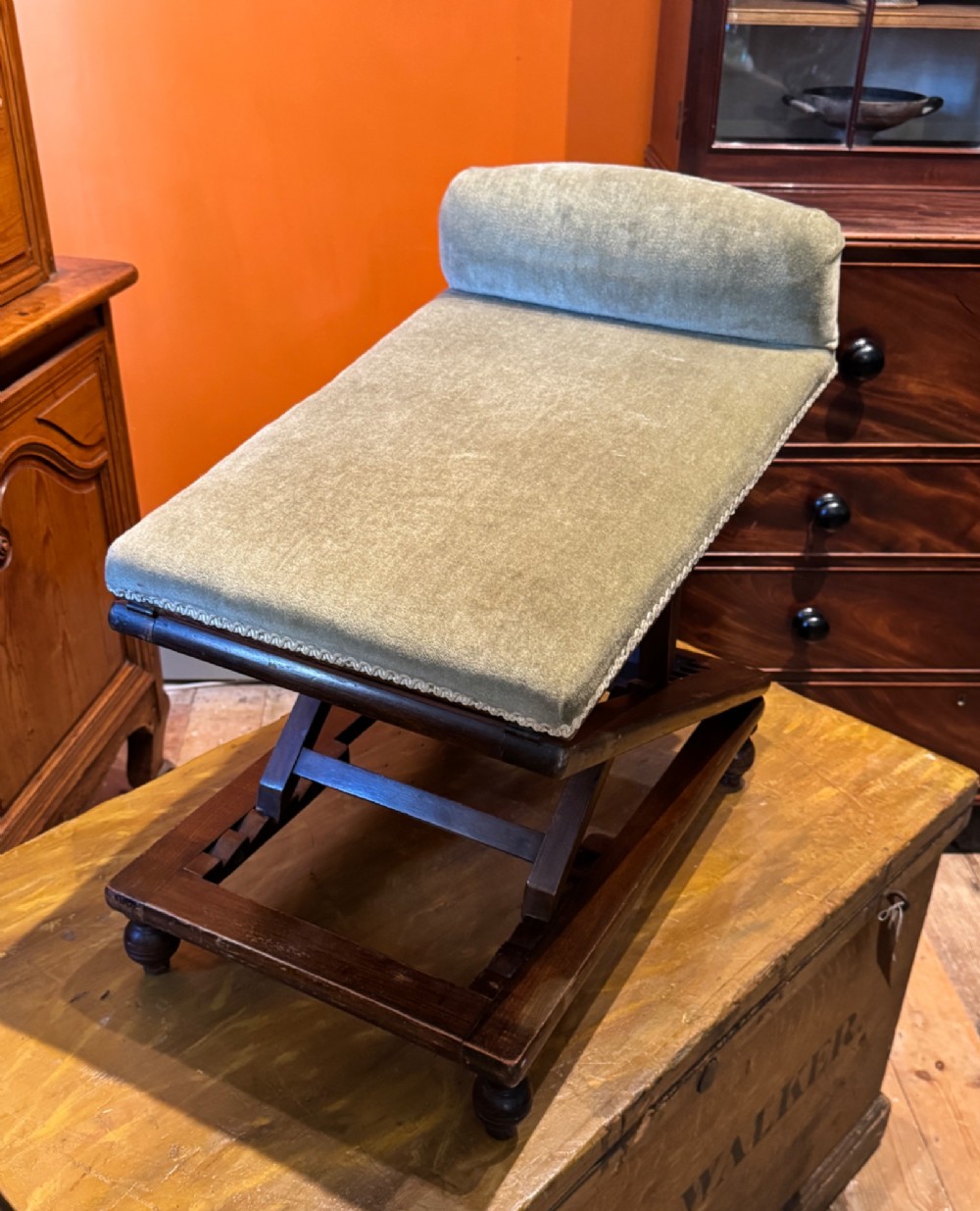 An antique Victorian metamorphic gout stool with a dark stained beech ratchet frame and an inclined green velvet upholstered cushion. View VIII