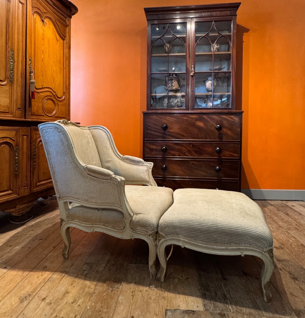 A French Louis XV style duchesse brisee comprising a painted armchair and matching footstool with cabriole legs and neutral upholstery. View II