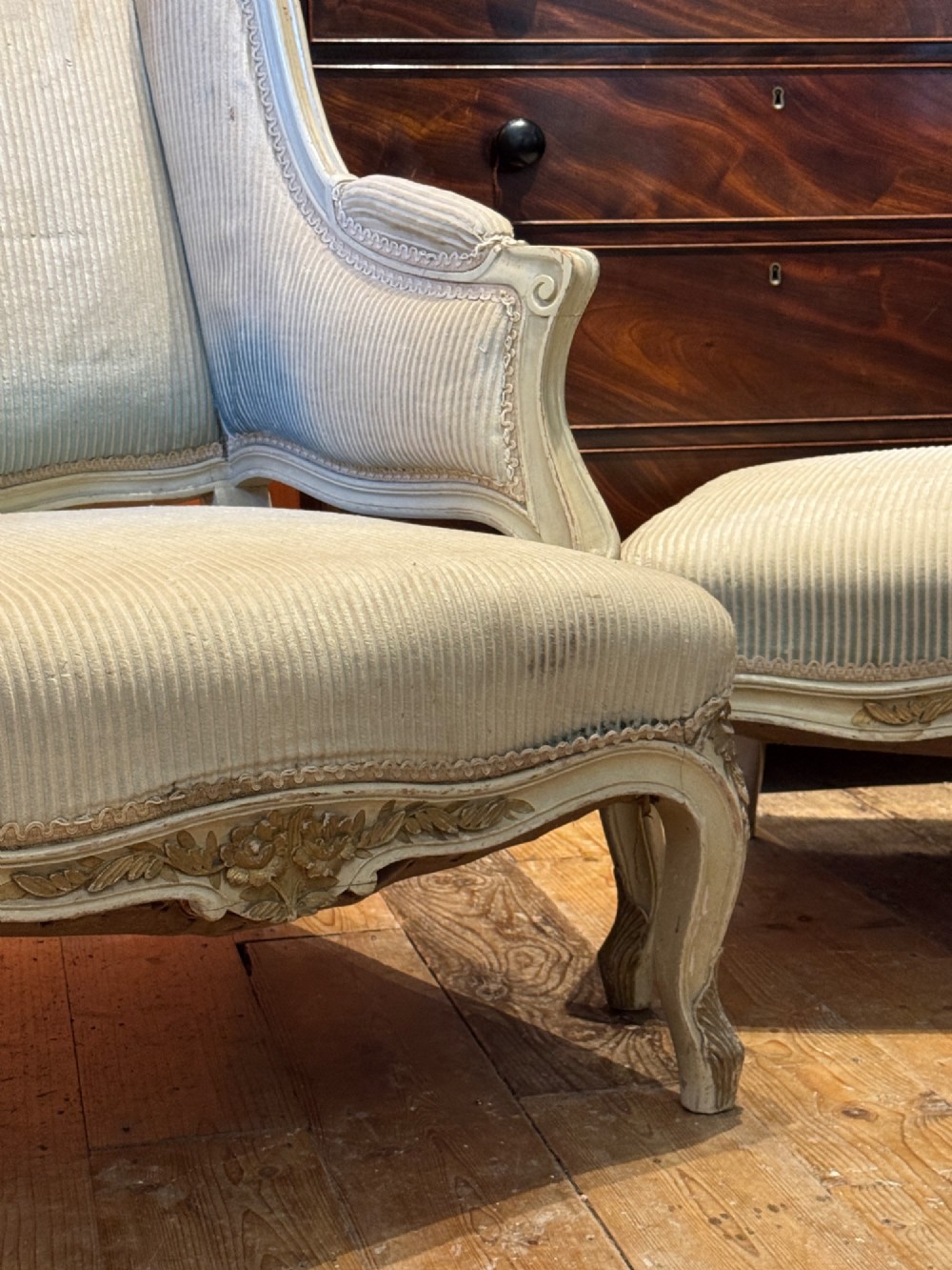 A French Louis XV style duchesse brisee comprising a painted armchair and matching footstool with cabriole legs and neutral upholstery. View V