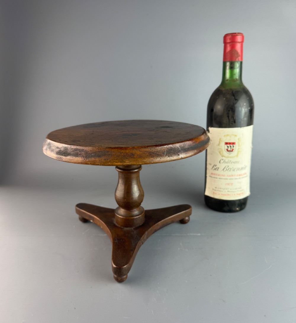 A Victorian turned mahogany treen candlestand crafted in the form of a miniature circular tripod tilt-top table. View II