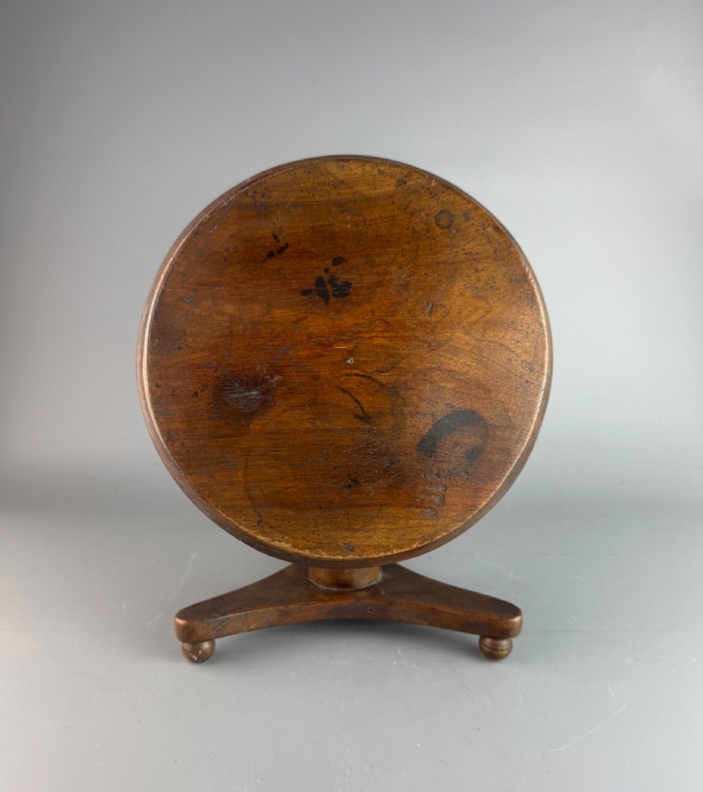 A Victorian turned mahogany treen candlestand crafted in the form of a miniature circular tripod tilt-top table. View III