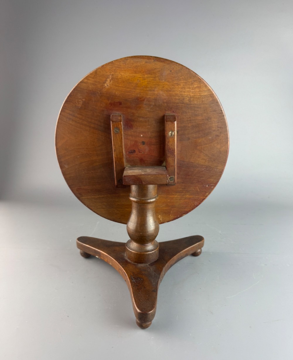 A Victorian turned mahogany treen candlestand crafted in the form of a miniature circular tripod tilt-top table. View IV