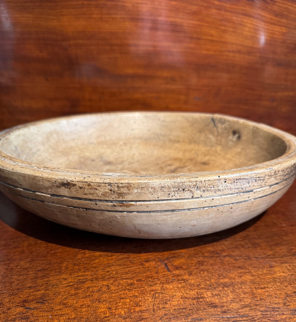A shallow 19th-century French hand-turned sycamore dairy bowl featuring incised concentric rim lines and natural wood patination. View II