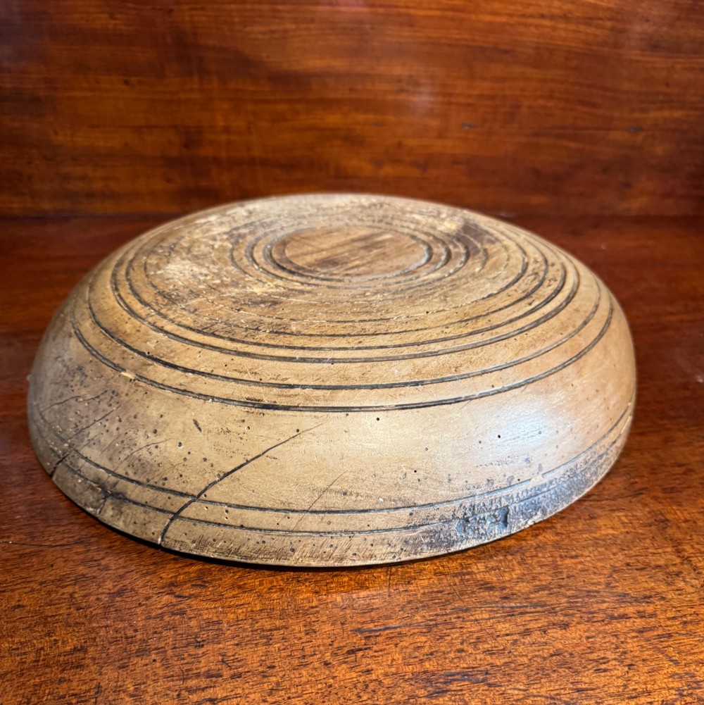 A shallow 19th-century French hand-turned sycamore dairy bowl featuring incised concentric rim lines and natural wood patination. View IV