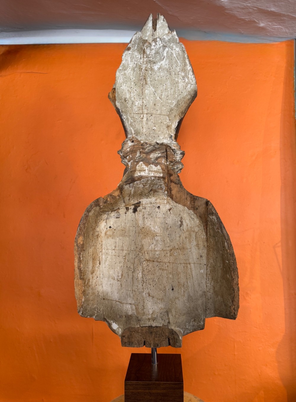 An eighteenth-century carved gilt-wood bust of a bearded bishop wearing a mitre, showing distressed gilding and mounted on a dark wooden block base. View III